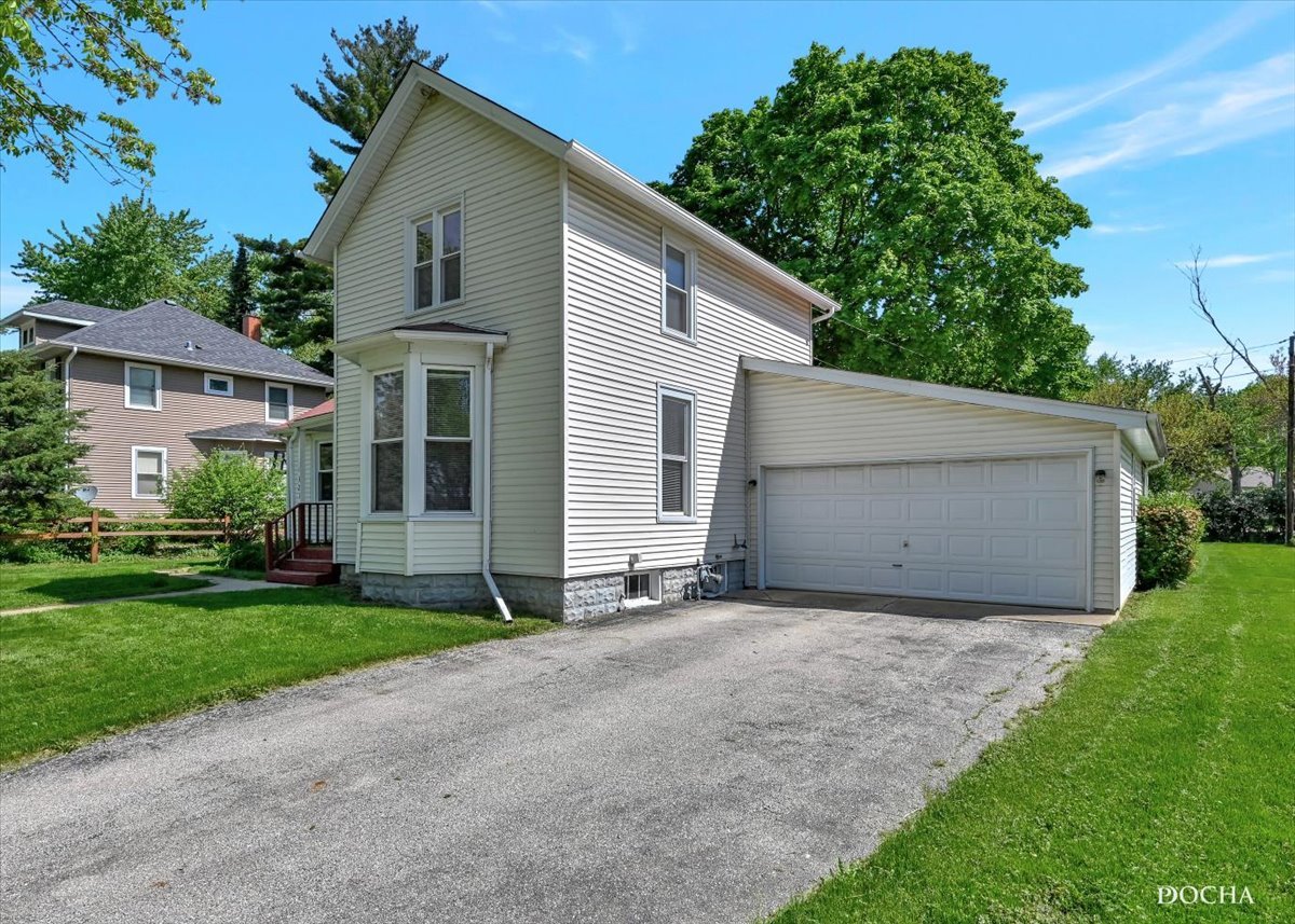 321 Fulton Street West Chicago, IL 60185 - Photo 17 of 21 a view of a house with a yard and garage