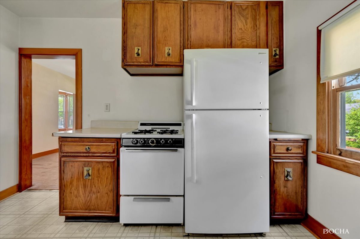 321 Fulton Street West Chicago, IL 60185 - Photo 6 of 21 a white refrigerator freezer and a stove sitting inside of a kitchen