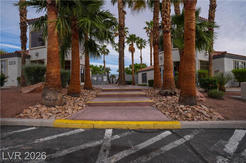 3318 North Decatur Boulevard, Unit 2152 Las Vegas, NV 89130 - Photo 55 of 58 A grand entrance welcomes residents with a stone pathway lined by numerous palms.