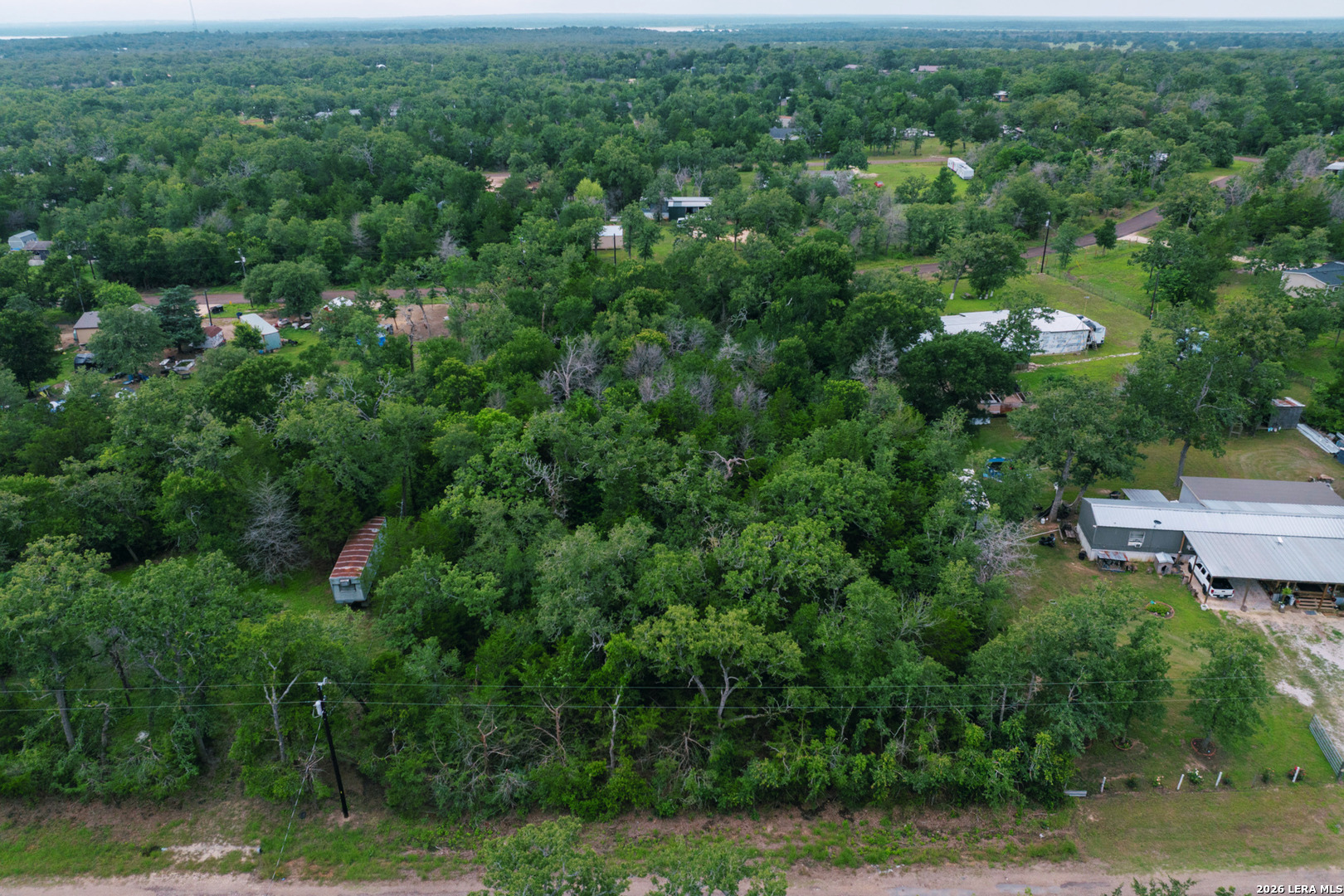 583 Blueberry Hill Road Somerville, TX 77879 - Photo 16 of 19 an aerial view of residential house with outdoor space and trees all around