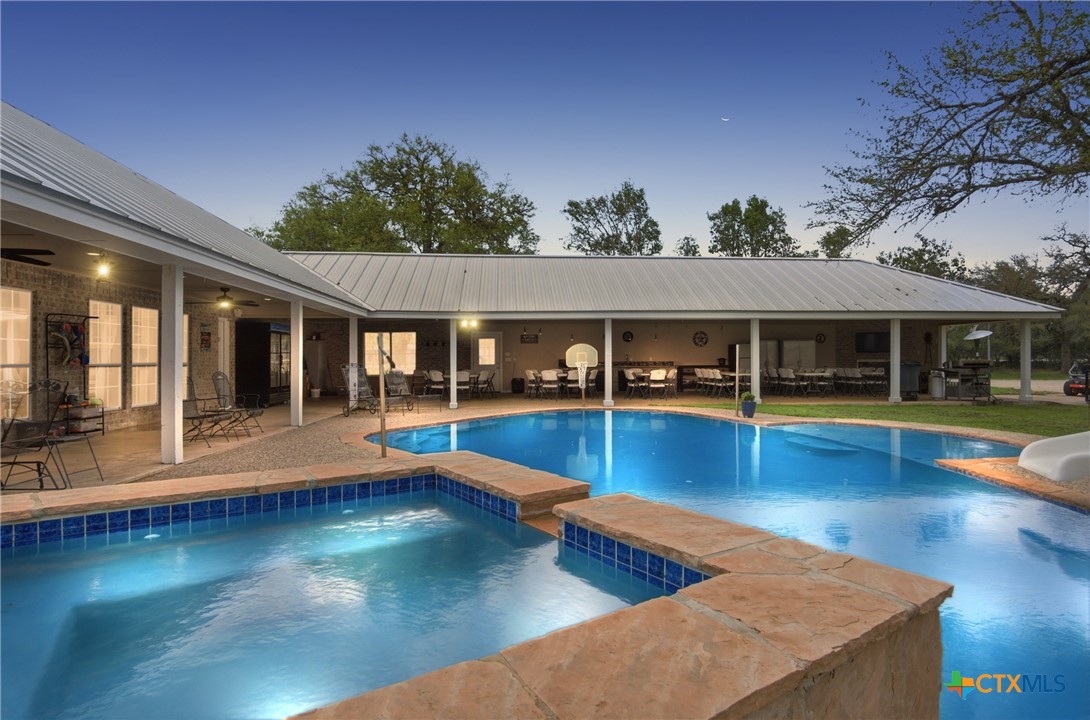 642 Phantom Rider Trail Spring Branch, TX 78070 - Photo 25 of 41 a view of swimming pool with seating space and large trees