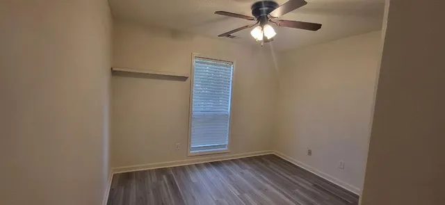 a view of room with hardwood floor and fan