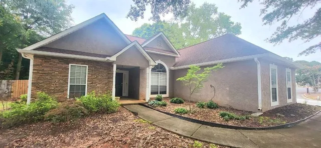 a front view of a house with garden