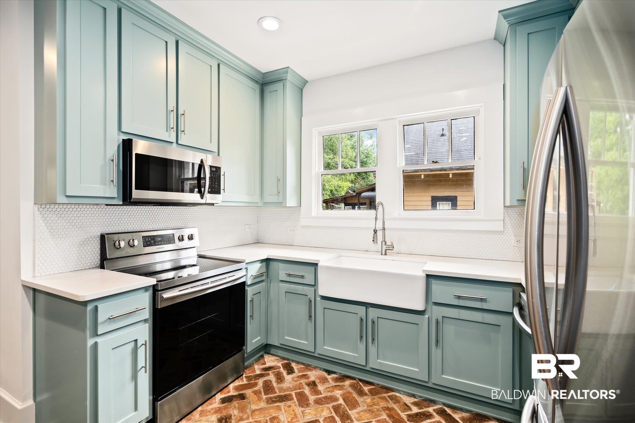 308 South Ann Street Mobile, AL 36604 - Photo 10 of 30 Kitchen featuring green cabinets, appliances with stainless steel finishes, decorative backsplash, and sink