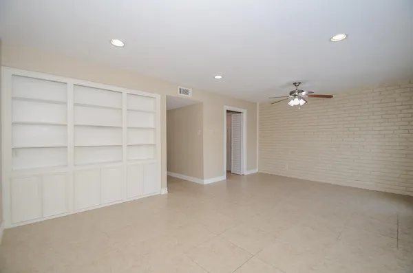 a bathroom with a granite countertop sink toilet and a mirror