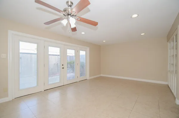 a view of a house with a small yard and potted plants