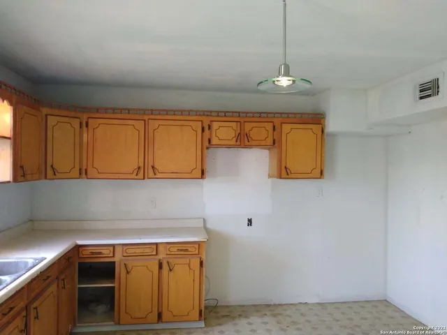 a kitchen with granite countertop sink cabinets and window