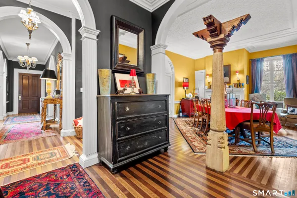 a view of a dining room with furniture and a chandelier
