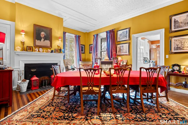 a dining room with furniture and a fireplace