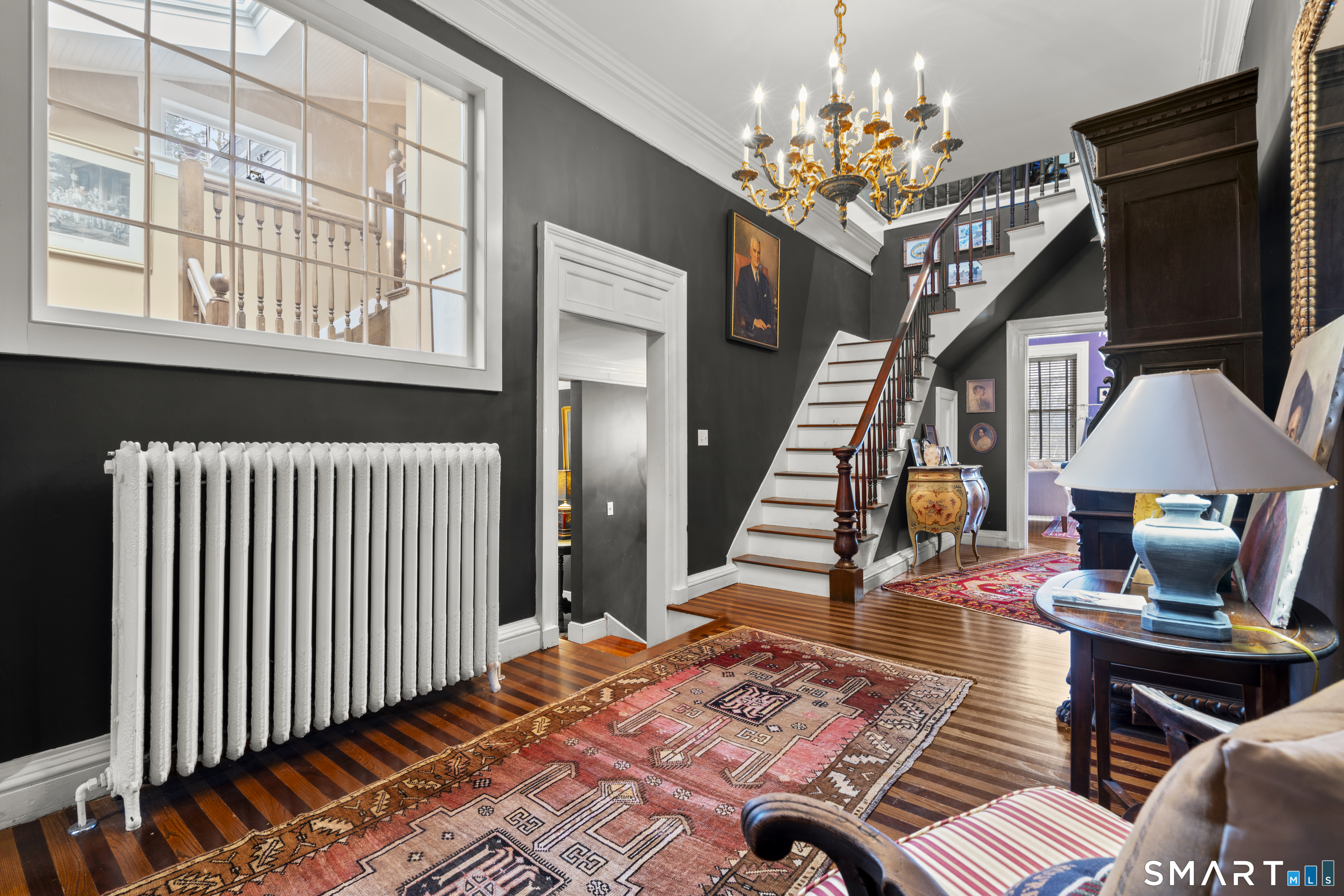 91 North Street Litchfield, CT 06759 - Photo 21 of 40 a living room with furniture and a chandelier