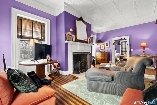 a living room with furniture a flat screen tv and a fireplace