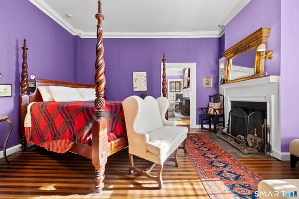 a living room with furniture a fireplace and windows
