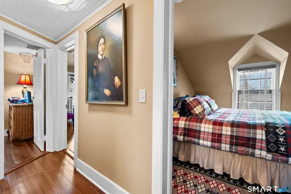 a bed room with a bed window and a chair