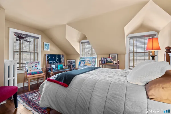 a bedroom with baby bed and a couch