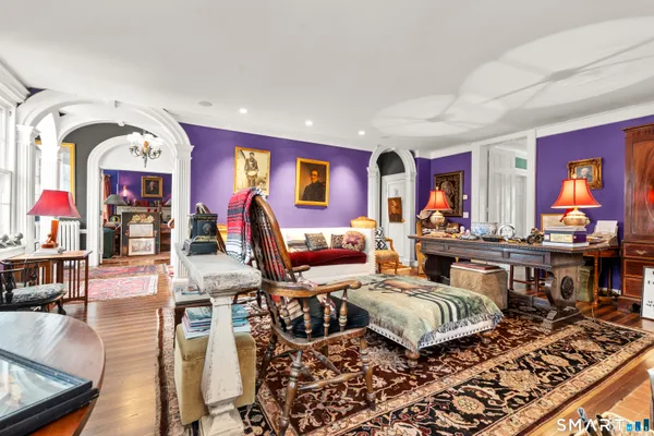 a living room with furniture and wooden floor