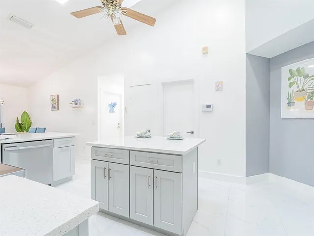 a spacious bathroom with a sink a vanity and a mirror