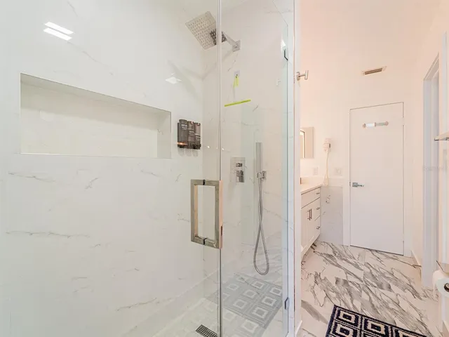 a bathroom with a shower and a sink