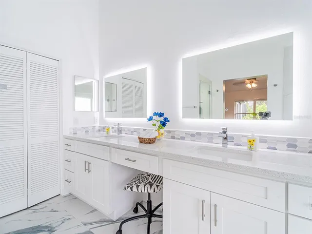 a bathroom with a sink double vanity and a mirror
