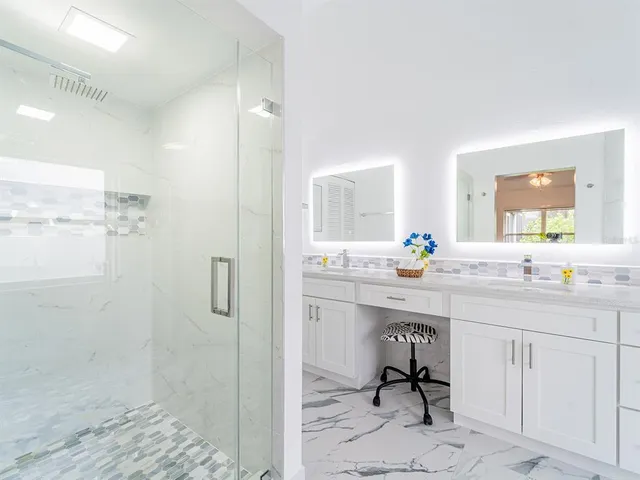 a spacious bathroom with a sink shower and a mirror