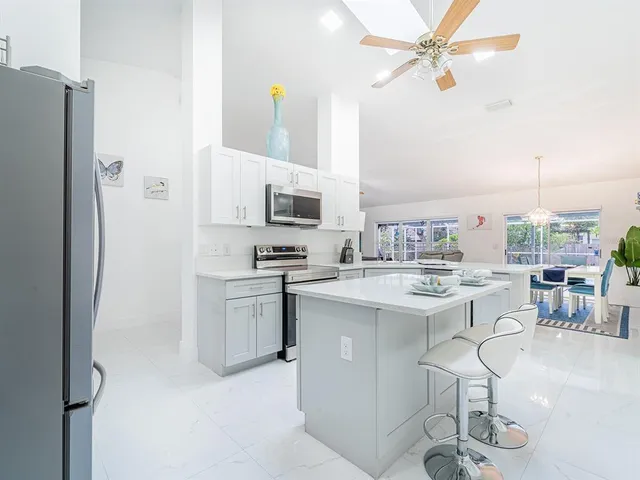 a kitchen with appliances a sink and cabinets