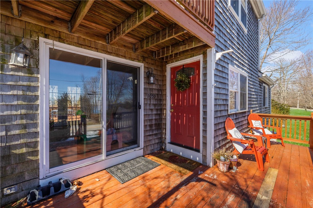 1059 East Shore Road Jamestown, RI 02835 - Photo 6 of 35 Front deck. Sliders to living room and front door to the right.