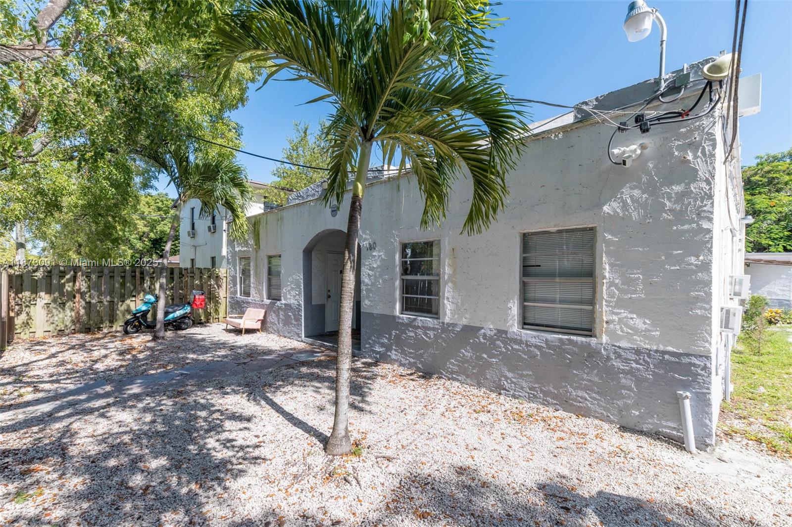 a view of a house with a patio and a yard