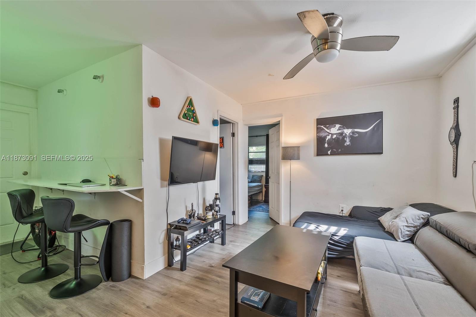 180 Northwest 59th Street Miami, FL 33127 - Photo 11 of 23 a living room with furniture and a flat screen tv