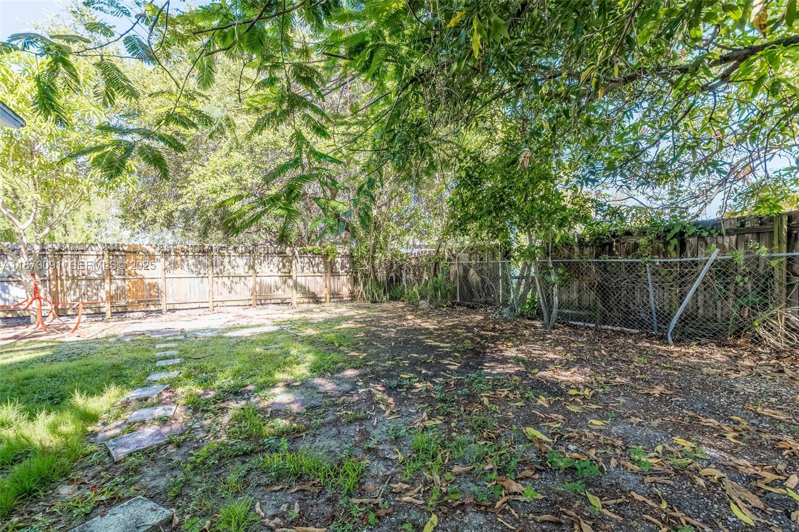 180 Northwest 59th Street Miami, FL 33127 - Photo 14 of 23 a view of a backyard with large trees