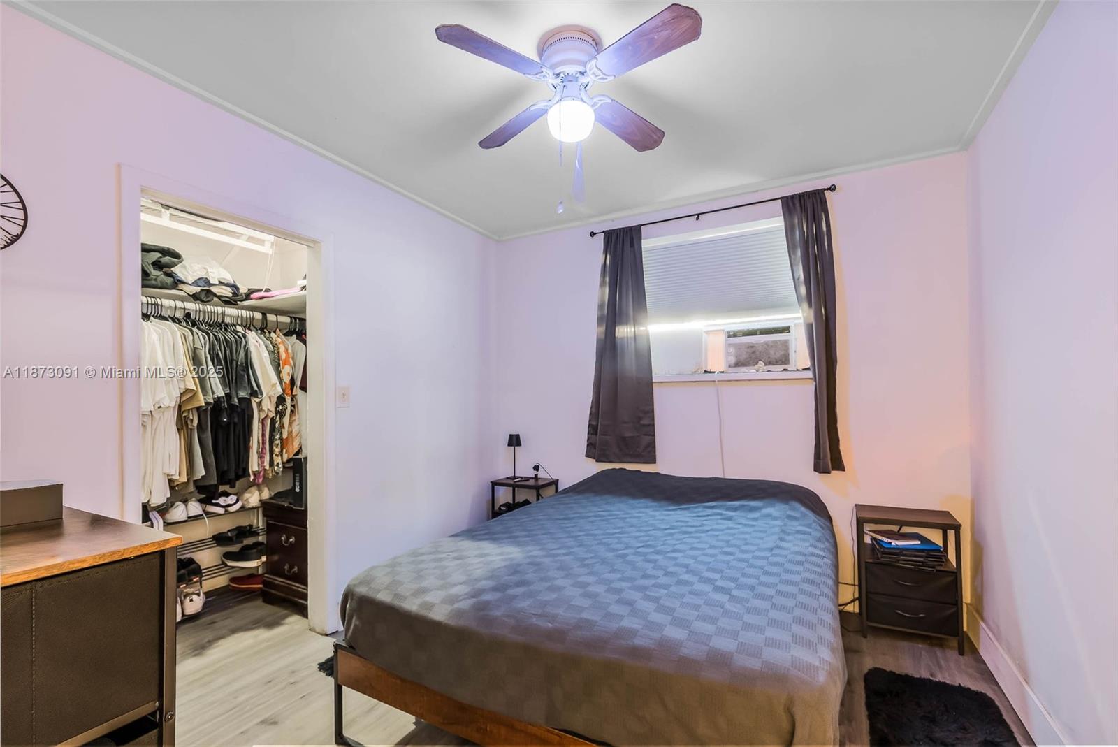 180 Northwest 59th Street Miami, FL 33127 - Photo 4 of 23 a bedroom with a bed and a chandelier