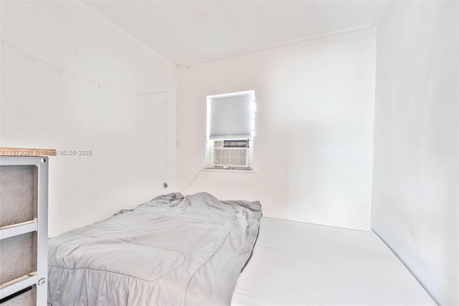 180 Northwest 59th Street Miami, FL 33127 - Photo 6 of 23 a bedroom with a bed and a window
