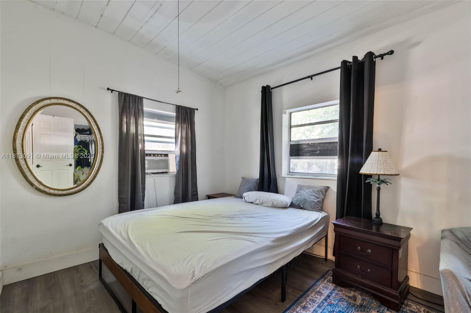 180 Northwest 59th Street Miami, FL 33127 - Photo 7 of 23 a bedroom with a bed and a painting on the wall