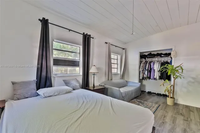 a bedroom with a bed table and a window