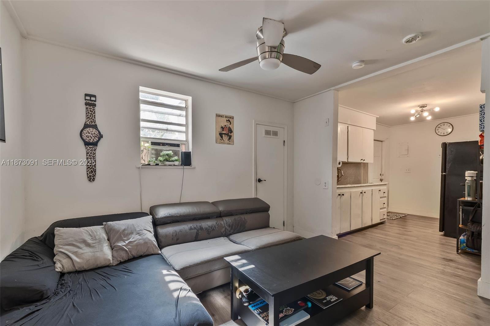 180 Northwest 59th Street Miami, FL 33127 - Photo 9 of 23 a living room with furniture and a flat screen tv