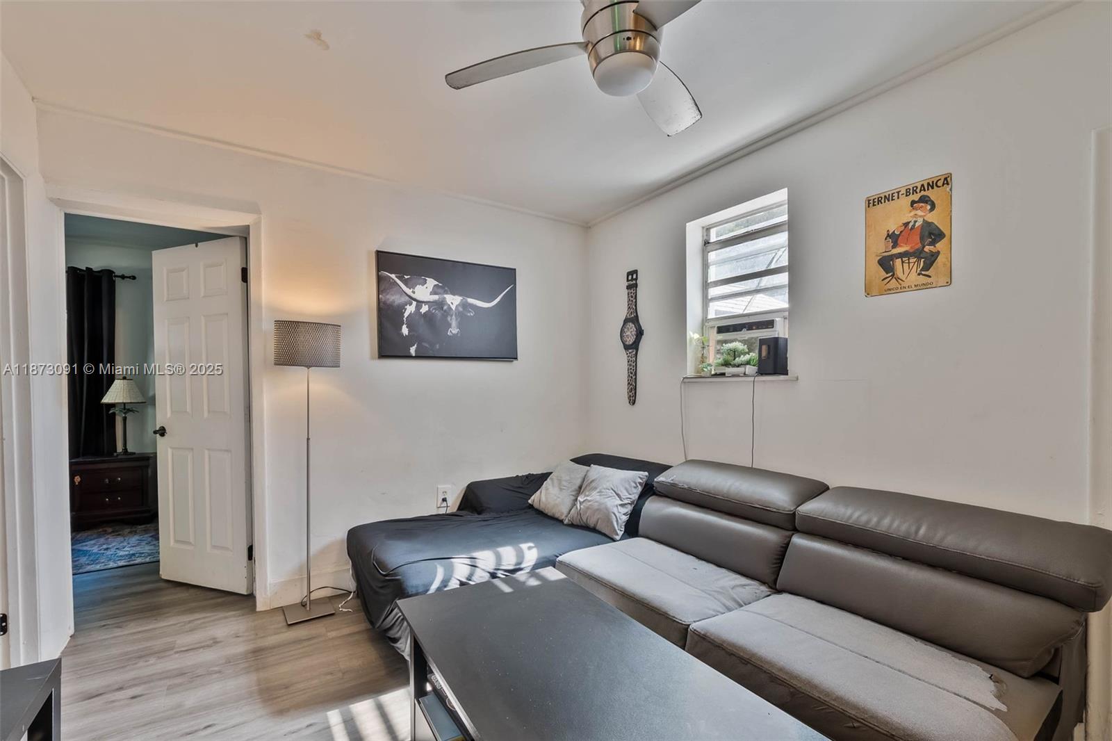 180 Northwest 59th Street Miami, FL 33127 - Photo 10 of 23 a living room with furniture and a wooden floor