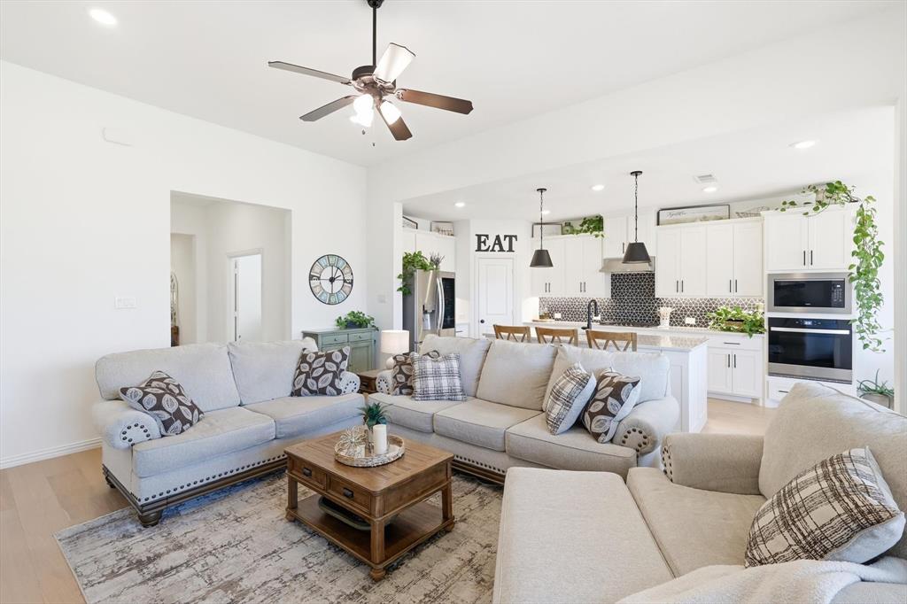 4420 Minnow Cove Oak Point, TX 75068 - Photo 12 of 40 a living room with furniture kitchen view and a chandelier