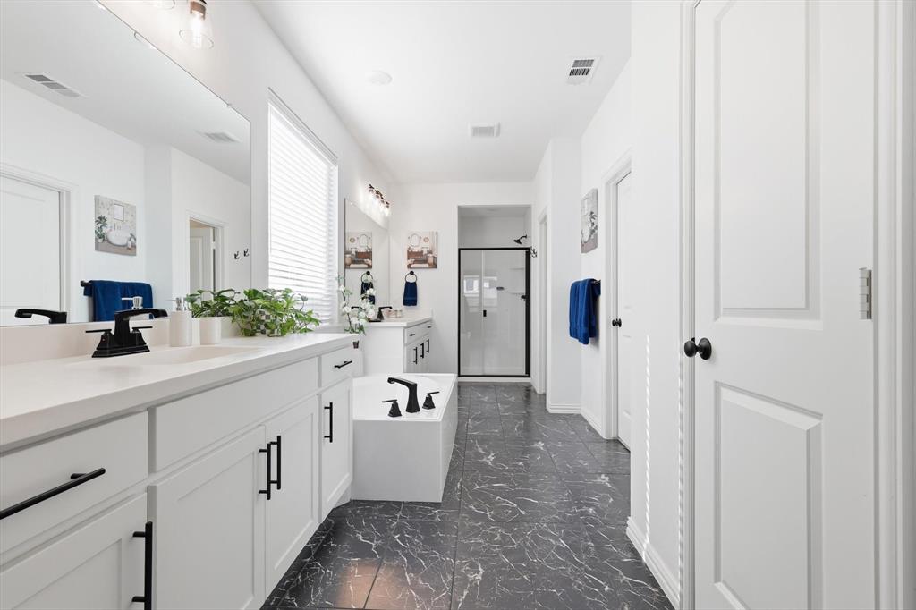 4420 Minnow Cove Oak Point, TX 75068 - Photo 23 of 40 a spacious bathroom with a shower sink and mirror