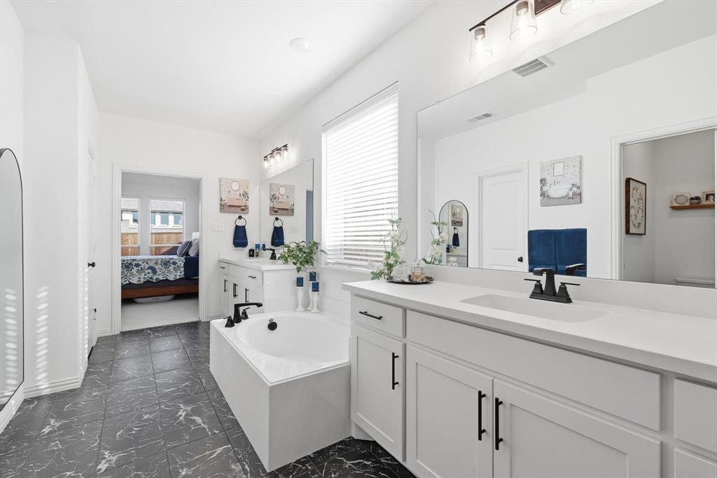 4420 Minnow Cove Oak Point, TX 75068 - Photo 24 of 40 a en suite bathroom with a double vanity sink
