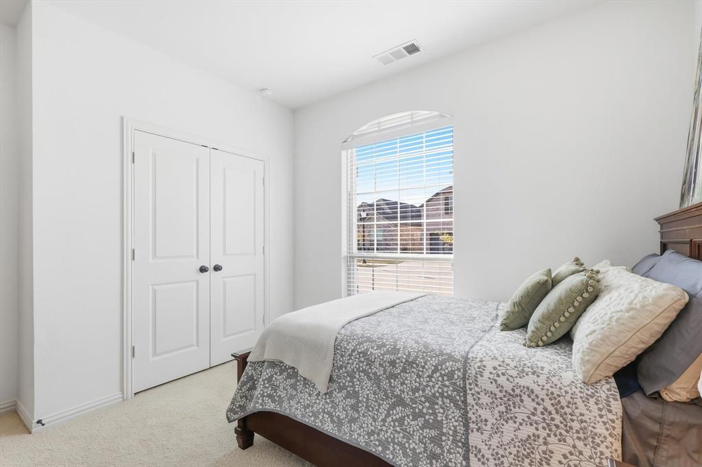 4420 Minnow Cove Oak Point, TX 75068 - Photo 27 of 40 a bedroom with a bed and a window