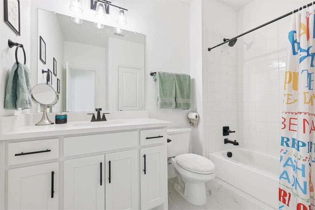 4420 Minnow Cove Oak Point, TX 75068 - Photo 28 of 40 a bathroom with a sink a toilet and shower