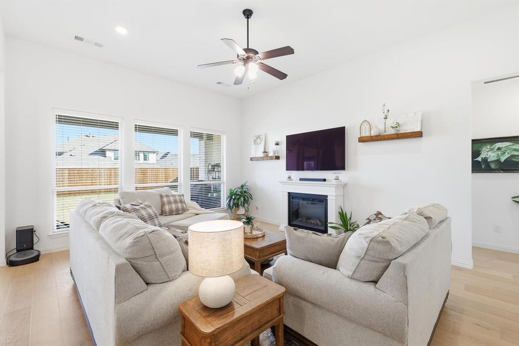 4420 Minnow Cove Oak Point, TX 75068 - Photo 7 of 40 a living room with furniture a fireplace and a flat screen tv