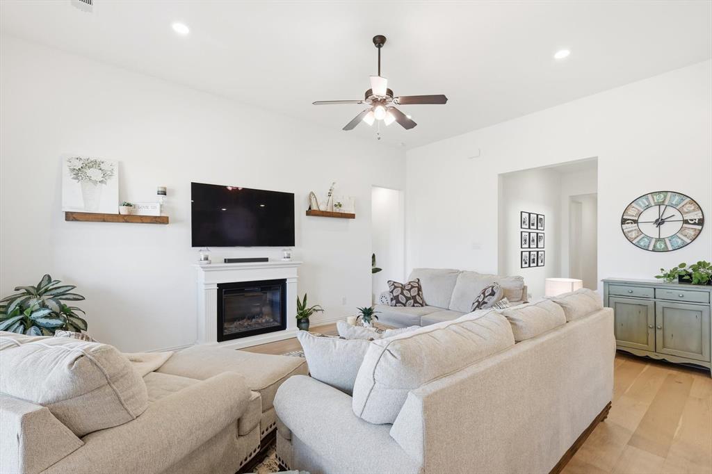 4420 Minnow Cove Oak Point, TX 75068 - Photo 8 of 40 a living room with furniture a fireplace and a flat screen tv