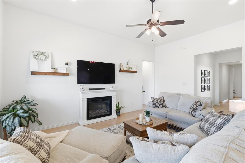 4420 Minnow Cove Oak Point, TX 75068 - Photo 9 of 40 a living room with furniture a fireplace and a flat screen tv