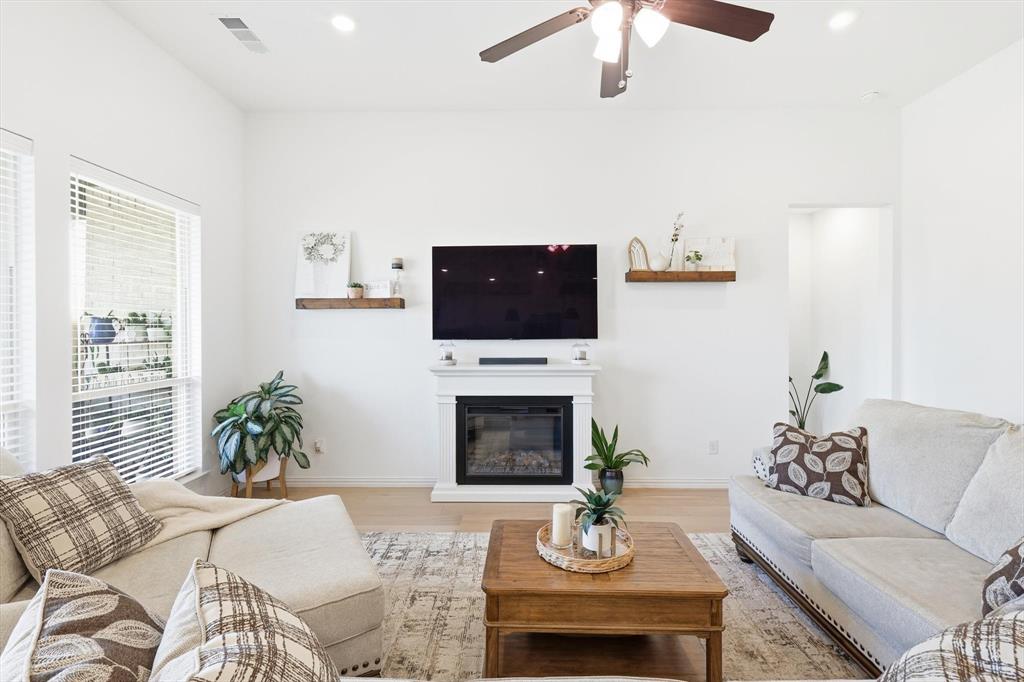 4420 Minnow Cove Oak Point, TX 75068 - Photo 10 of 40 a living room with furniture a fireplace and a flat screen tv