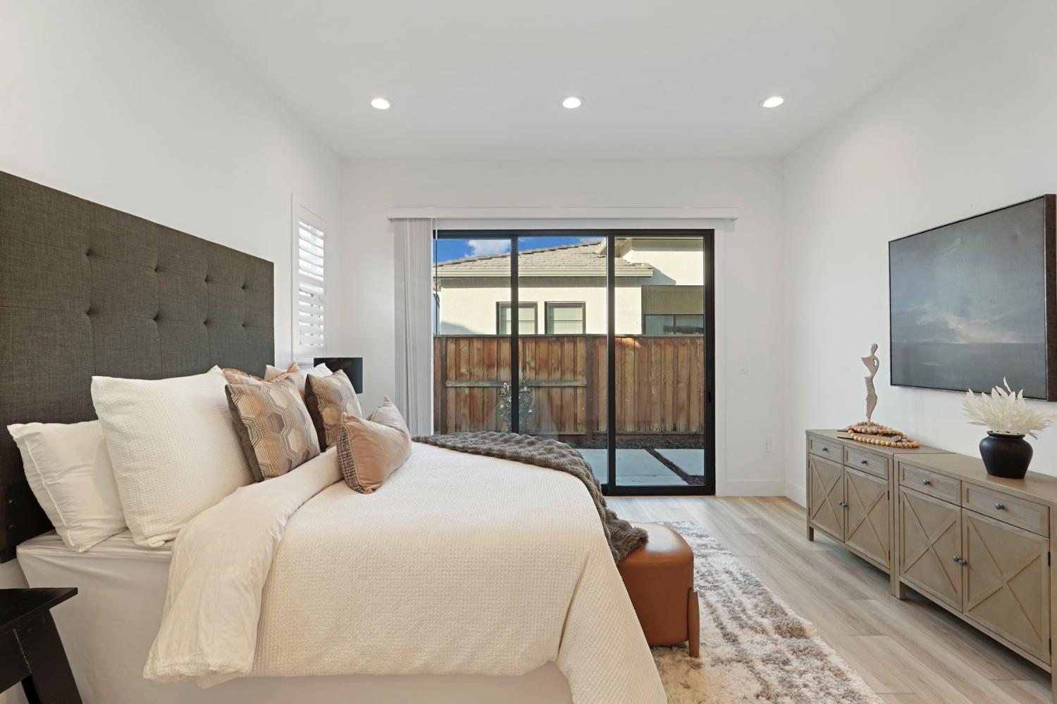 1839 Snowflower Place Tracy, CA 95377 - Photo 16 of 53 a bedroom with a large bed and a flat tv screen on dresser