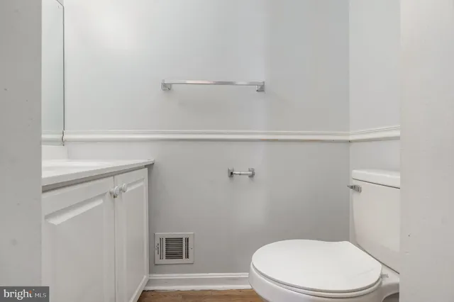 a white toilet sitting next to a shower