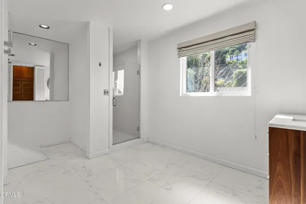 an empty room with windows and closet