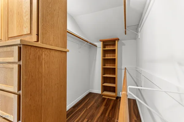 a view of walk in closet with empty racks