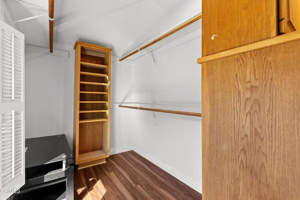 a view of closet area with wooden floor