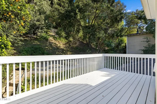 a balcony with wooden floor and fence