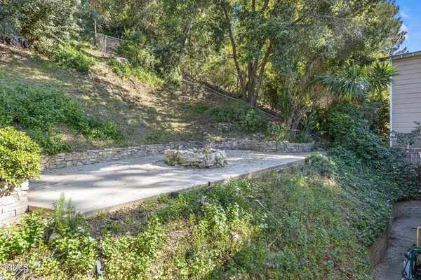 a view of a yard with large trees